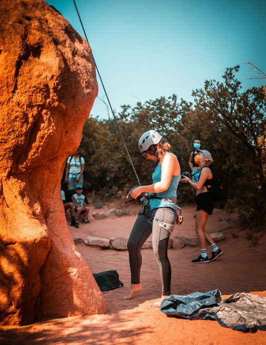 a group of people climbing up the side of a mountain