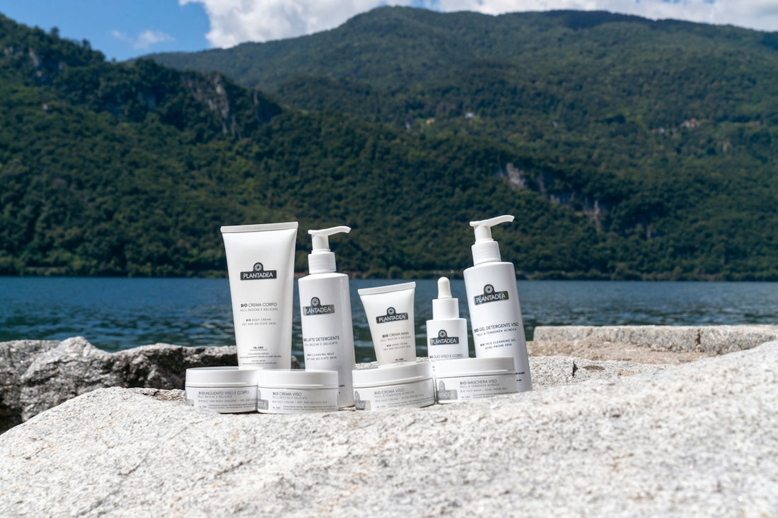Skincare products displayed with a mountain and lake background