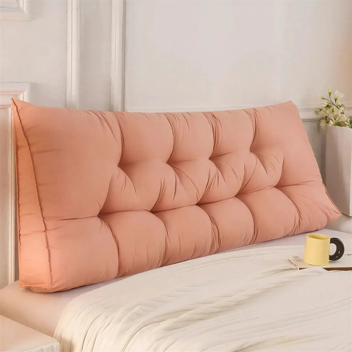 Zora triangular wedge headboard cushion on bed or sofa, providing comfortable support and decorative accent in a modern home setting.