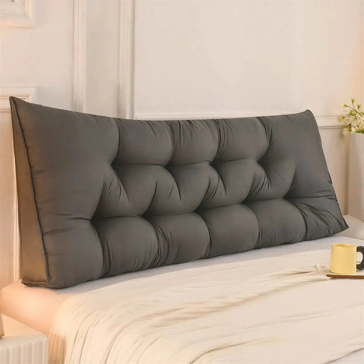 Zora triangular wedge headboard cushion on bed, providing comfortable support for bed and sofa use.