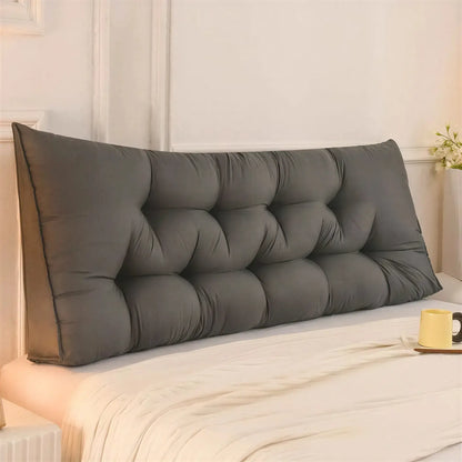 Zora triangular wedge headboard cushion on bed, providing comfortable support for bed and sofa use.