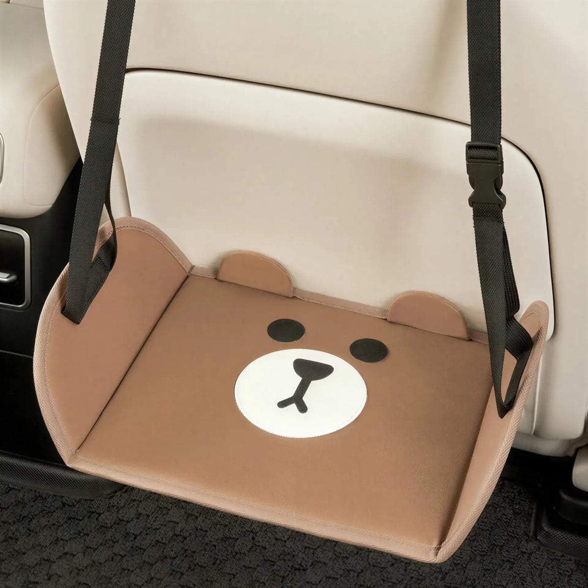 Zora adjustable car and travel foot hammock attached to car seats, providing comfortable foot support during travel.