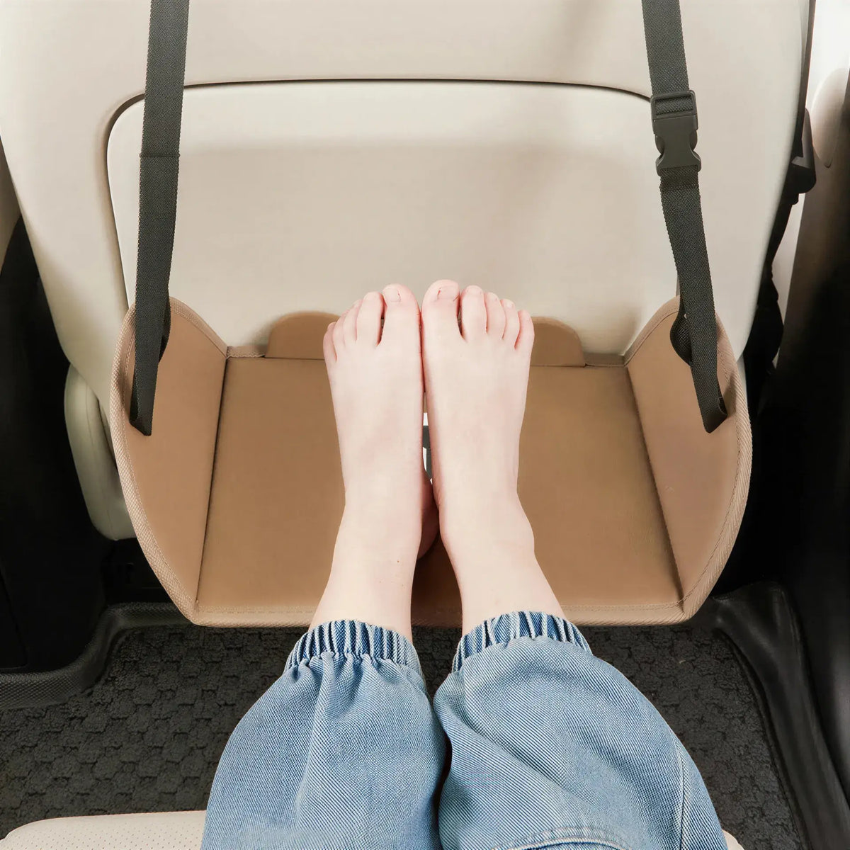 Zora adjustable car and travel foot hammock attached to car seats for comfortable leg support during travel.