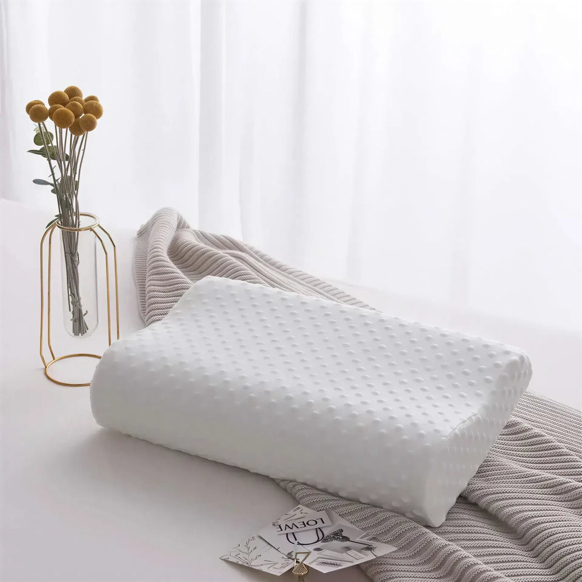 Zora adjustable memory foam pillow for side sleepers showing the ergonomic design and soft cover material.